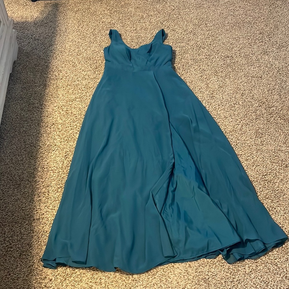 Green prom dress with slit at the bottom. Ties into a bow at the back.
